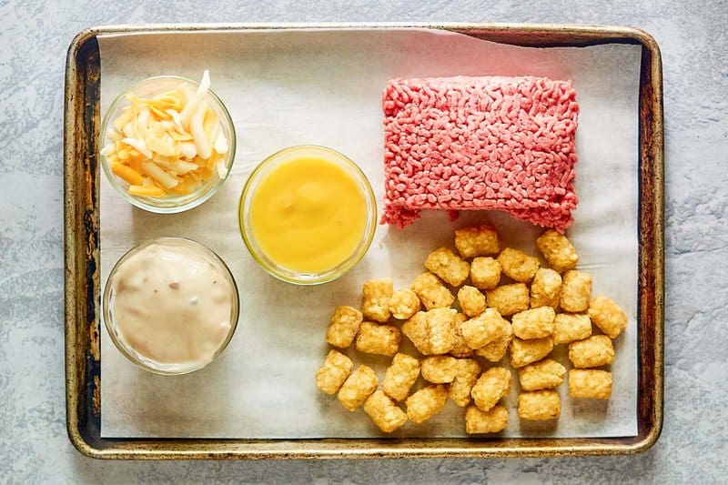 Mexican tater tot casserole ingredients on a tray.