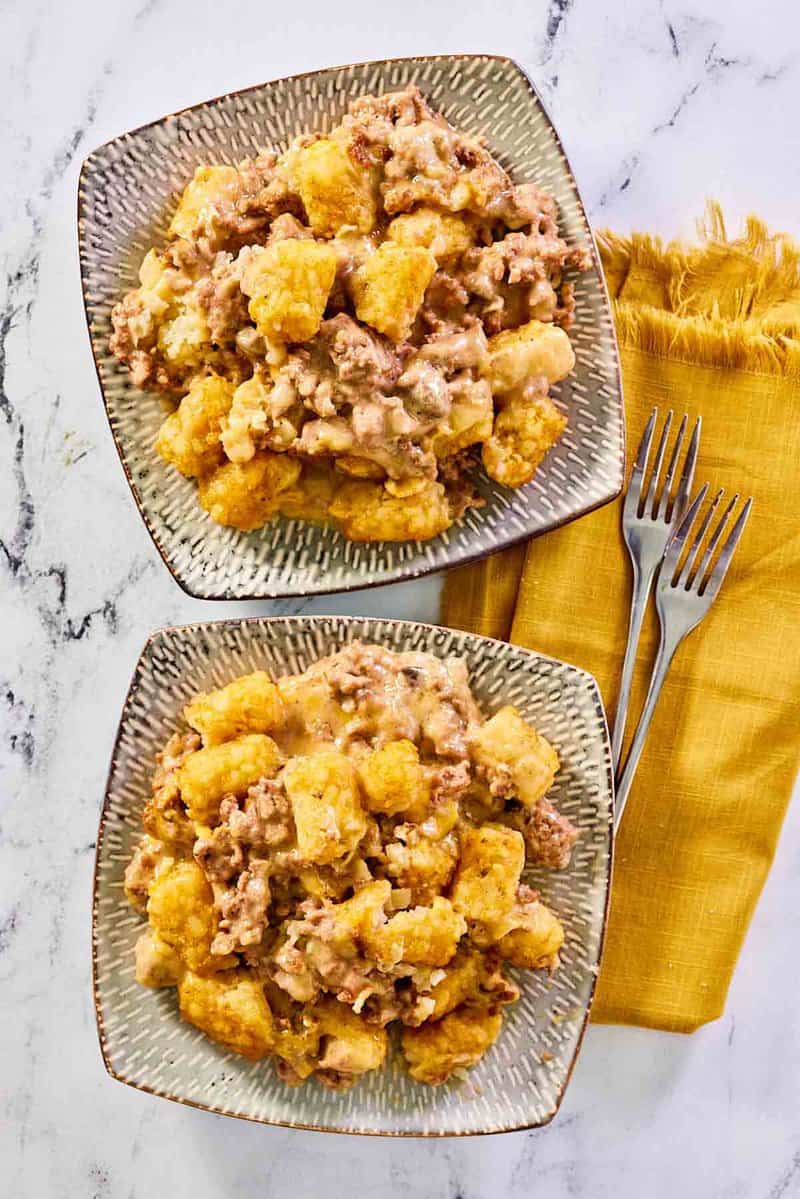 overhead view of Mexican tater tot casserole on two square plates.