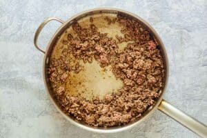 browned ground beef in a pan.