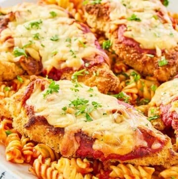 copycat Olive Garden chicken parmigiana and pasta on a platter.