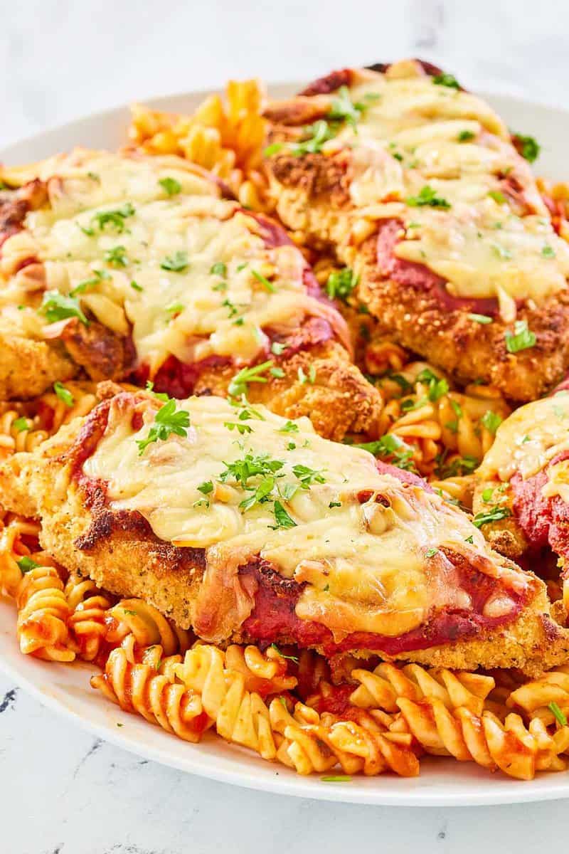 copycat Olive Garden chicken parmigiana and pasta on a platter.