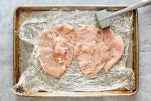 pounding chicken breasts into thin chicken cutlets.