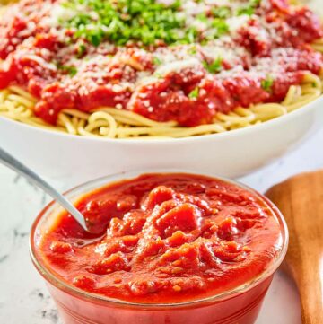 copycat Olive Garden marinara sauce in a bowl and over spaghetti.