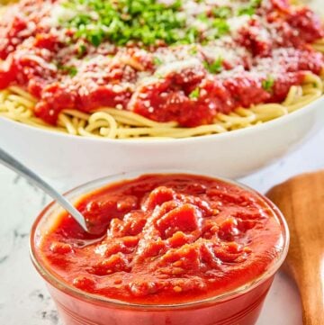 copycat Olive Garden marinara sauce in a bowl and over spaghetti.