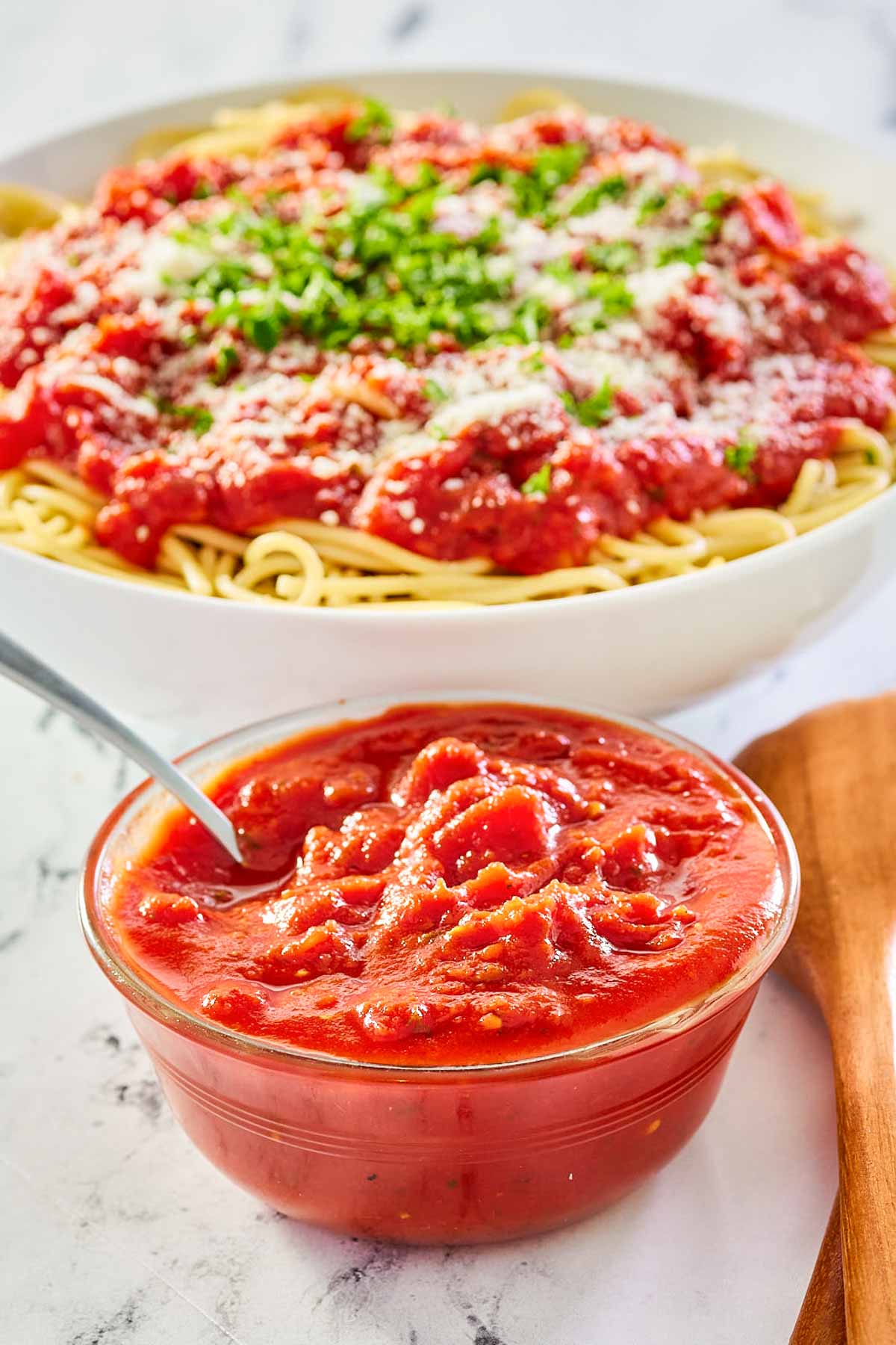 copycat Olive Garden marinara sauce in a bowl and over spaghetti.