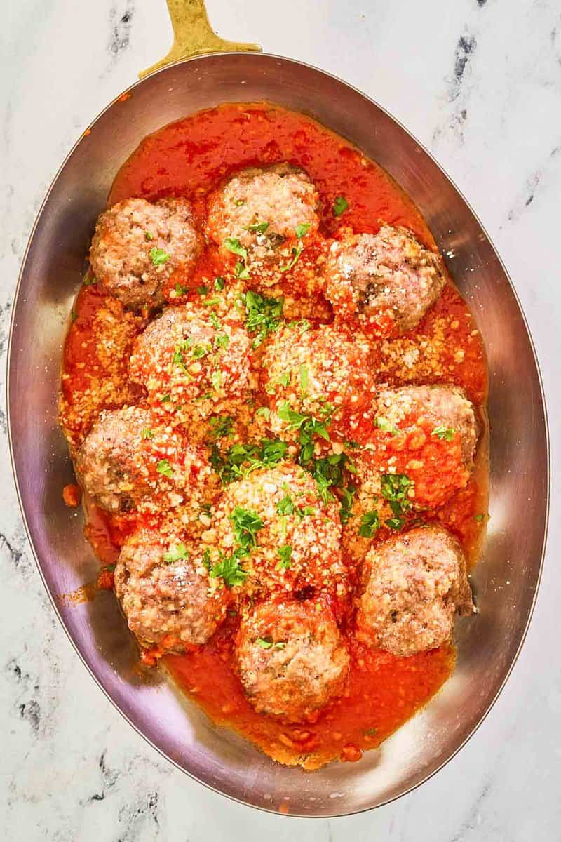 overhead view of copycat Olive Garden meatballs and marinara in a skillet.