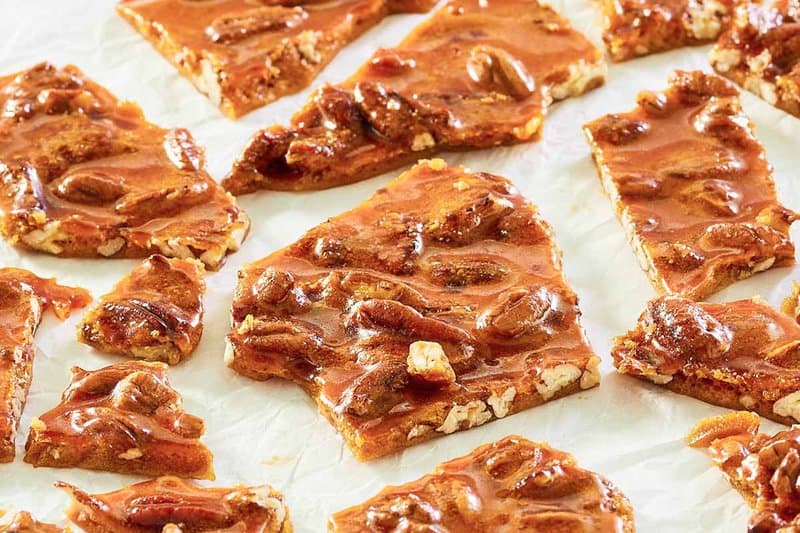 pecan brittle candy pieces on parchment paper.