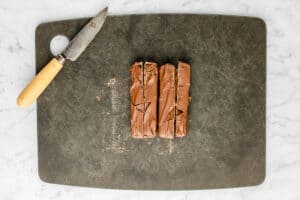 sliced Milky Way candy bars on a cutting board.