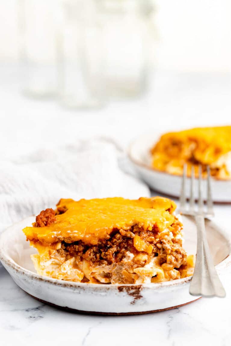 sour cream noodle bake serving and a fork on a plate.