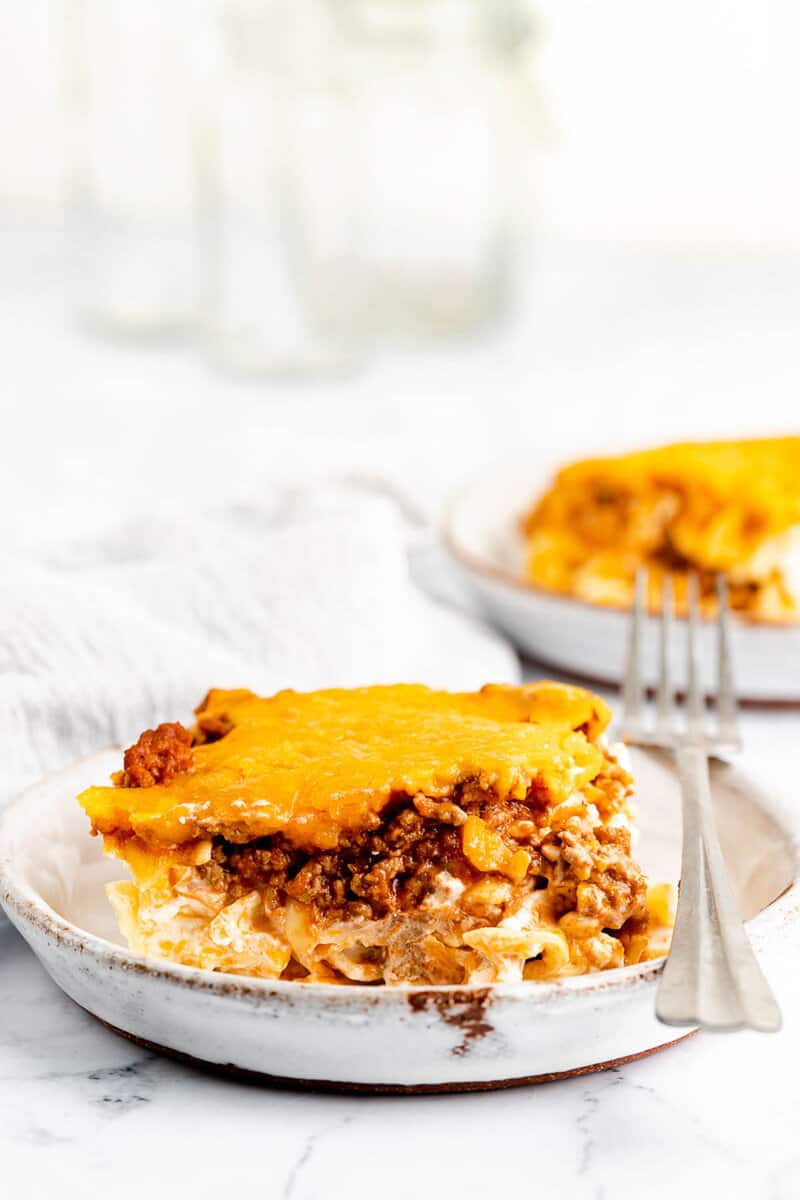 sour cream noodle bake serving and a fork on a plate.