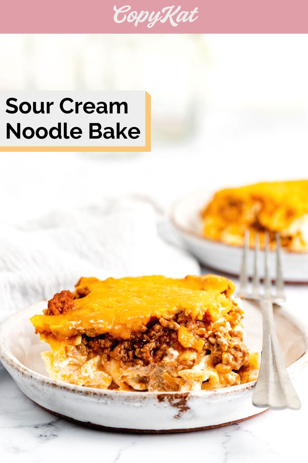 sour cream noodle bake servings on white plates.