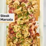 overhead view of steak marsala on a long platter.