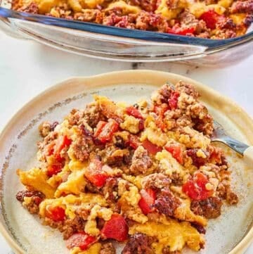 beef tamale casserole in a baking dish and a serving on a plate.