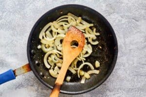 sliced onions in a skillet.