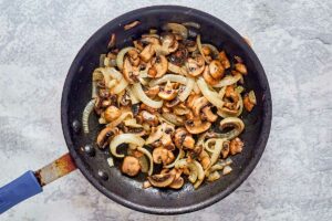 cooked onions and mushrooms in a skillet.
