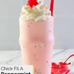 homemade chick fil a peppermint milkshake with whipped cream and a cherry on top.