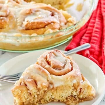 copycat Cracker Barrel cinnamon roll pie slice on a plate in front of the pie.