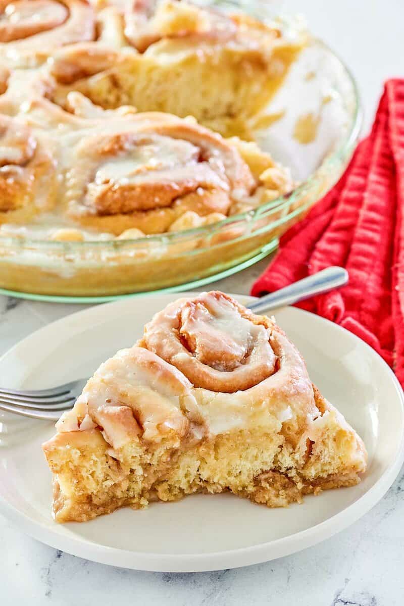 copycat Cracker Barrel cinnamon roll pie slice on a plate in front of the pie.