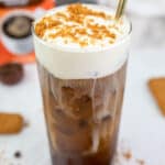copycat Dunkin cookie butter cold brew with cold foam and a straw.