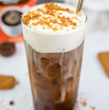 copycat Dunkin cookie butter cold brew with cold foam and a straw.