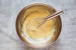 pancake batter and a whisk in a bowl.