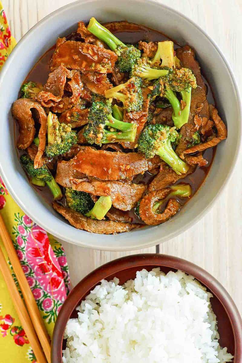 overhead view of copycat Panda Express broccoli beef and a bowl of rice.