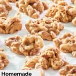 homemade pecan pralines scattered on parchment paper.