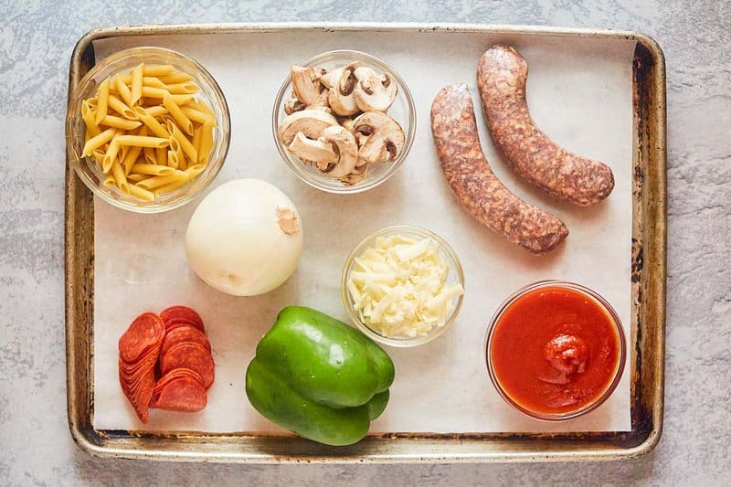 ingredients for pizza bowls on a tray.