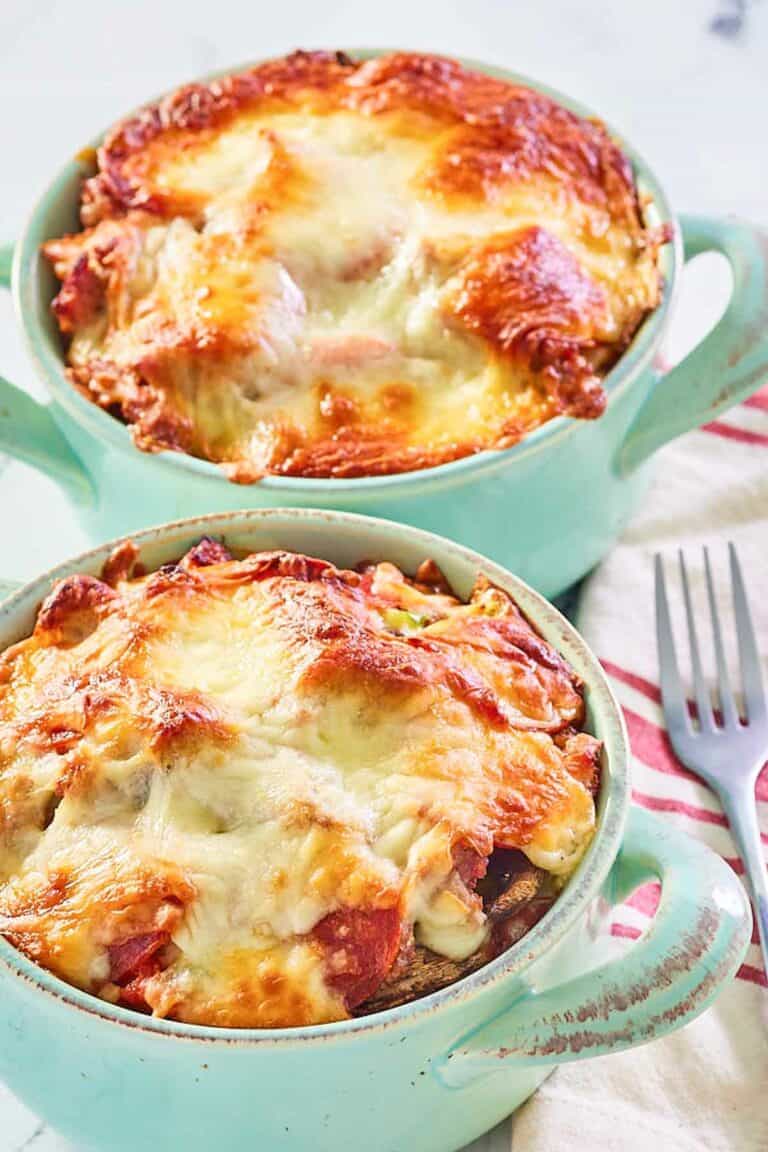 two pizza bowls with melted mozzarella cheese on top.