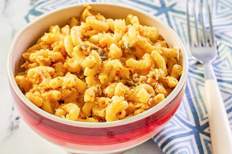 a bowl of spicy mac and cheese and a fork.