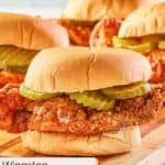 four homemade wingstop buffalo chicken sandwiches with pickles.