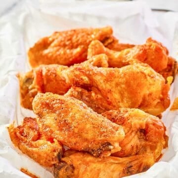 copycat Wingstop Cajun wings in a wire serving basket.