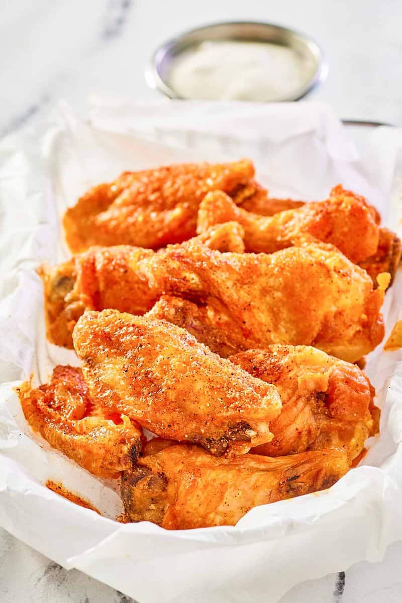 copycat Wingstop Cajun wings in a wire serving basket.