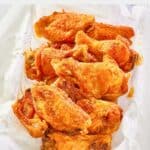 homemade Wingstop Cajun wings in a parchment paper lined basket.