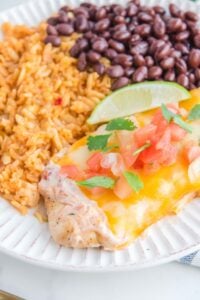 Copycat Applebee's fiesta lime chicken, rice, and achromatic  beans connected  a plate.