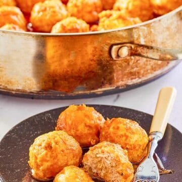 Buffalo chicken meatballs on a plate and in a pan.