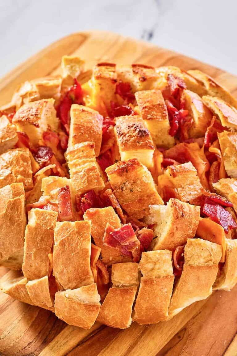 cheesy pull apart bread on a wood board.