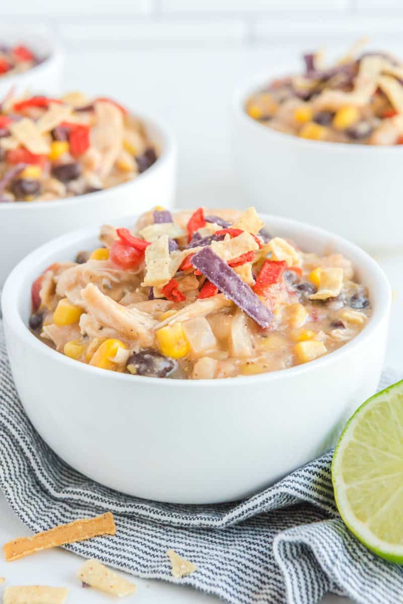 Copycat Chick Fil A chicken tortilla soup in white bowls.