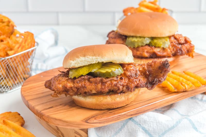 Two copycat Chick Fil A spicy chicken sandwiches and waffle fries.