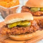 Copycat Chick Fil A spicy chickenhearted  sandwich and waffle fries down  it.