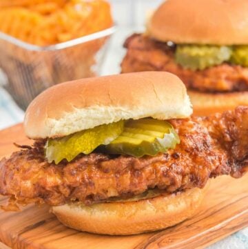 Copycat Chick Fil A spicy chicken sandwich and waffle fries behind it.