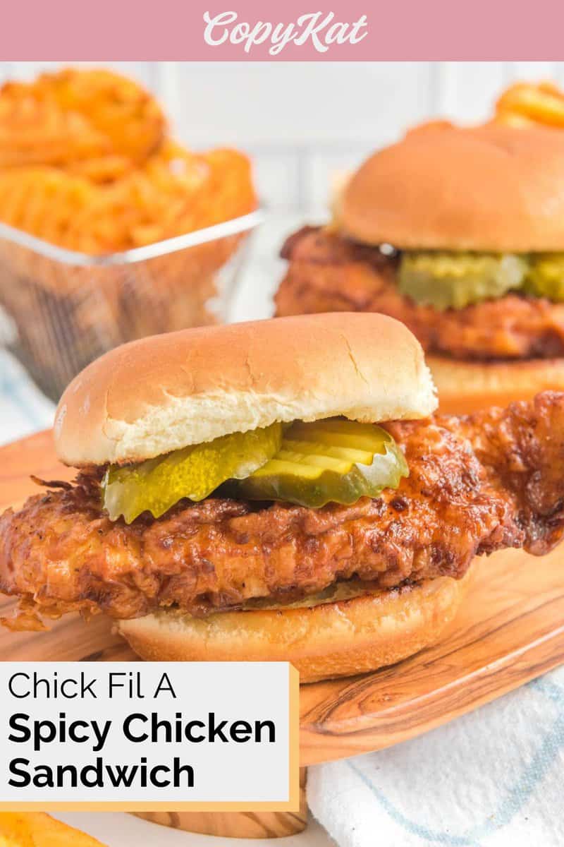 Homemade Chic Fil A spicy chicken sandwich and waffle fries behind it.