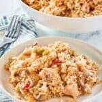 chicken and rice casserole in a serving bowl and on a plate.