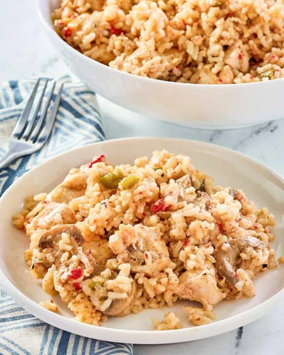 chicken and rice casserole in a serving bowl and on a plate.