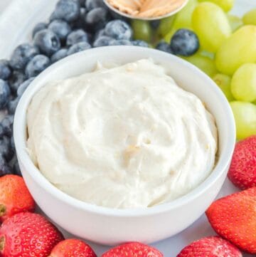 Cream cheese fruit dip, strawberries, grapes, blueberries, and toothpicks.