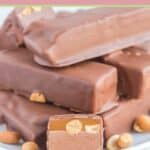 homemade snickers candy bars and peanuts on a plate.