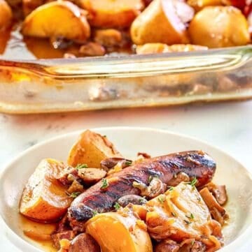 Irish coddle serving on a white plate in front of it in a baking dish.