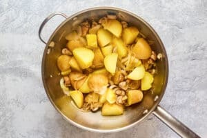 cooked potatoes and onions in a pan.