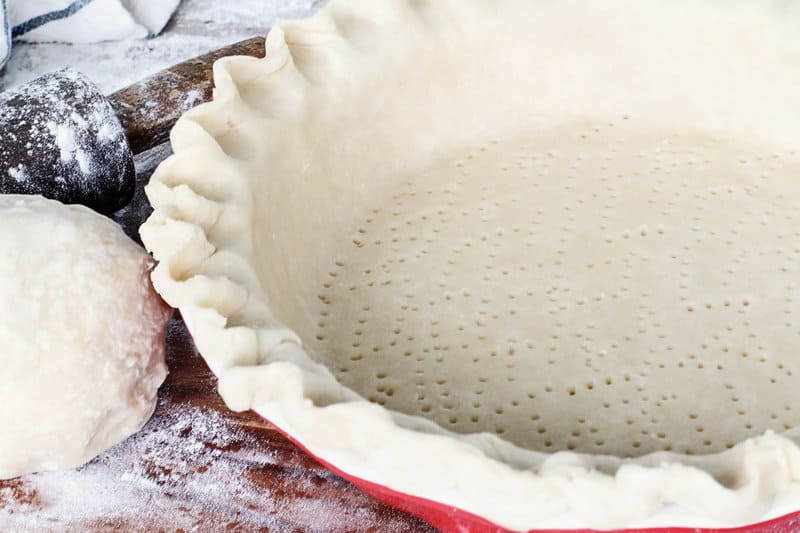 Martha Stewart pie crust in a pie plate and a ball of dough next to it.
