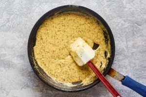 Mustard cream sauce in a skillet.